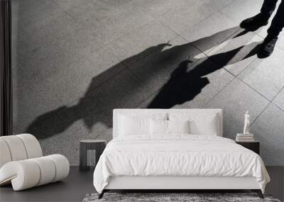 Dark shadow of a lonely person on the ground in the street. Stranger with a cigarette. Anxiety, depression, loneliness, fear concept. Wall mural