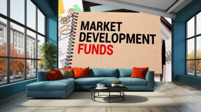 Market Development Funds text written on a notebook with office background. Wall mural