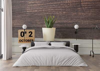 October 2 on a wooden calendar on a table or shelf. Wall mural