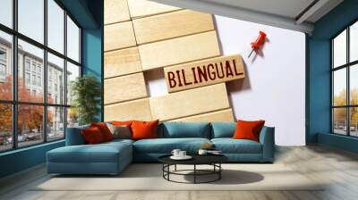 On a white table a flower, a notebook with the word BILINGUAL Wall mural