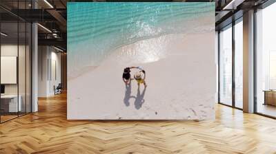 Beautiful beach with white sand and clear blue sea. Couple on the beach Wall mural