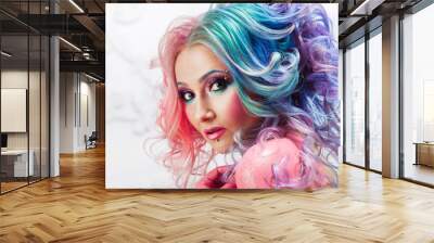 Beautiful woman with bright hair. Bright hair color, hairstyle with curls. Wall mural