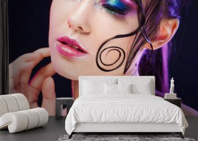 Young beautiful girl bright makeup with a wet look shine, dark background Wall mural