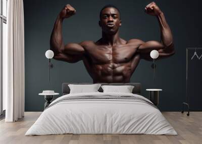 Black man on dark isolated background showing his biceps Pumped up man without a t-shirt Wall mural