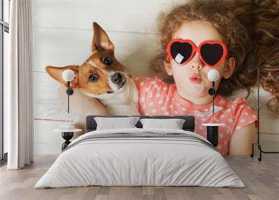 Cute friend lying on a wooden floor. Wall mural