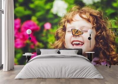 Laughing girl with a butterfly on his nose. Wall mural