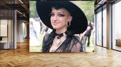 Young, smiling, female goth in black outfit on the annual Wave Gotik Treffen (Wave Gothic Meeting) in Leipzig Wall mural