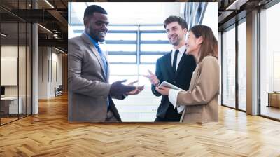 Business people shaking hands. finishing up a meeting. team of business people walk in rush hour at indoor pedestrian stairs and talk together. concept negotiations in feeling successful and happy. Wall mural