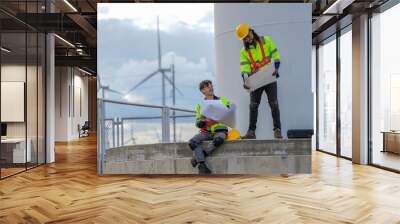 engineer worker builders looking drawing for construction. Concept people working on fieldwork of windmill turbines. the future of clean energy resources for low carbon and sustainability. Wall mural