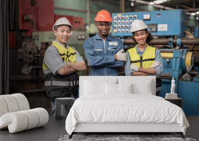 Group of Diversity factory worker people standing when success the project and celebrating together in local warehouse, asian, white caucasian and asian people in heavy machine at industry factory. Wall mural