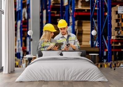 man and woman worker walking and checking stock for shipping. Female inspecting the store factory. Logistics employees holding folders at on site warehouse area for shipping transportation. Wall mural