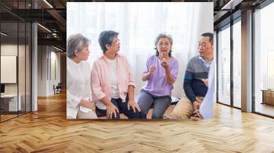 senior females and male sitting on bench. older people are listening and enjoy meeting focus group at living room. Joyful carefree retired senior friends enjoying relaxation at nearly home. Wall mural