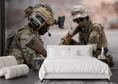 Soldiers in camo gear during a tactical operation with binoculars and rifles on a rocky terrain, showcasing military precision and readiness. Wall mural