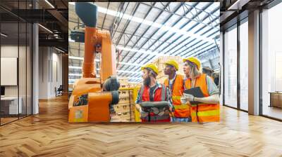 team Engineers standing by robotic arm and operating machine in factory. worker man control on tablet. Workers work at heavy machine robot arm. High-tech robot with a remote system in Wood factory. Wall mural