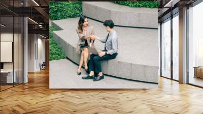 Two business man and woman shake hands outside a modern office building and successful business dealings. professionalism in a corporate setting. reflecting of collaboration and strategic planning. Wall mural