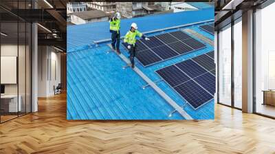 Worker Technicians are working to construct solar panels system on roof. Installing solar photovoltaic panel system. Men technicians walking on roof structure to check photovoltaic solar modules. Wall mural