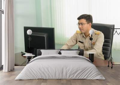 A Thai government officer, Civil servant using a personal computer in the office. Wall mural