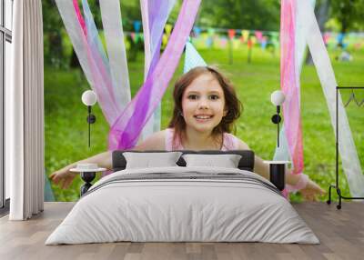 cheerful little girl outdoors , celebrate a birthday. Cheerful children's holiday outdoors.
 Wall mural