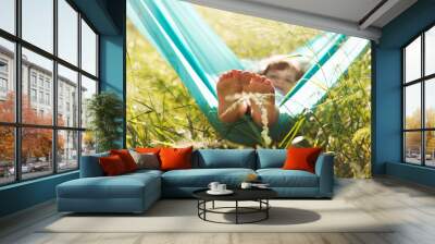 child girl  lies in a hammock and have fun in the park in the summer Wall mural