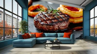 Grilled steak with onion rings and rosemary garnish. Wall mural