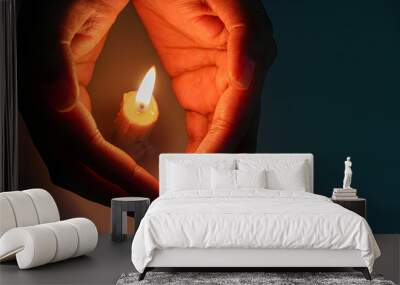 hand  guarding candle flame  Wall mural