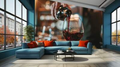 Close-up shot of red wine pouring in a glass. Red wine pouring close-up, restaurant service.  Wall mural