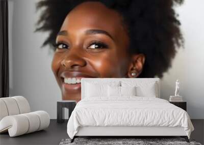 Smiling young African woman with natural afro hair and striped shirt against a white background. Wall mural