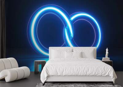 Two intersecting neon blue rings glowing brightly in a dark space, creating a modern and futuristic ambiance. Wall mural