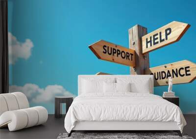 Wooden signpost with arrows pointing towards help, guidance, support, and advice against a bright blue sky with clouds. Wall mural