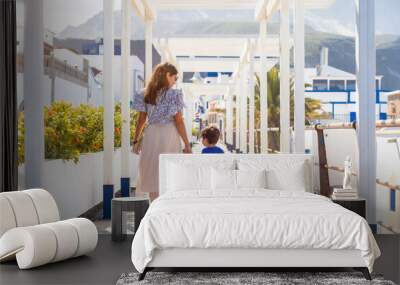 A mother with her son on vacation at Puerto de Las Nieves in Agaete on Gran Canaria, Spain Wall mural