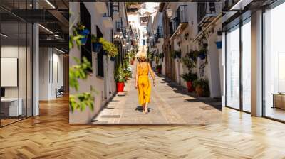 a tourist in mijas visiting the white houses and charming town and the slopes in malaga. andalusia Wall mural