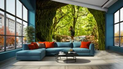 A young woman trekking in the cave at Levada do Caldeirao Verde, Queimadas, Madeira Wall mural