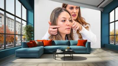 Aesthetic doctor showing facial improvements to a patient Wall mural