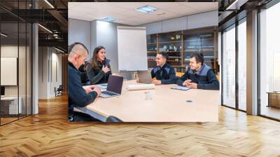 Group of engineers talking during a meeting in a fabric Wall mural