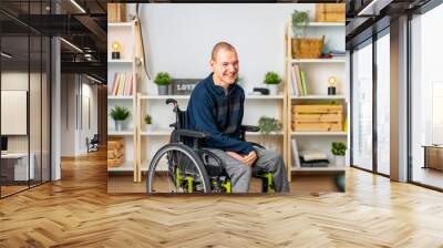 Happy disabled man in wheelchair smiling in the living room Wall mural