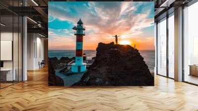 Lifestyle of a girl visiting the lighthouse at a sunset in Punta de Teno, Tenerife (Canary Islands) Wall mural