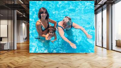 Mother and grandmother having fun with grandson in swimming pool on summer vacation Wall mural