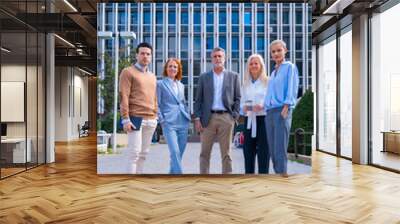 Portrait of cheerful group of coworkers walking outdoors in a corporate office area, Caucasian middle age group Wall mural