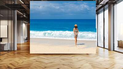 Thoughtful woman looking at the sea at Megali Petra beach with turquoise water of Lefkada island, Ionian Sea, Greece Wall mural