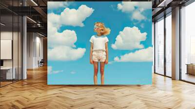 Portrait of a little cute, cheerful girl standing in children's clothes under a clear blue sky. White dense clouds background. Illustration, Generative AI. Wall mural