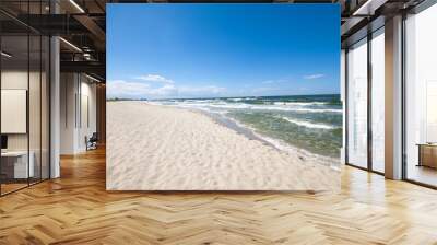 Empty, sandy beach and sea waves by sunny day Wall mural