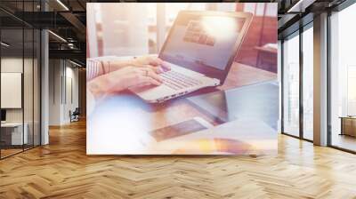 Close-up view of interior designer workspace with laptop, graphic tablet, phone and color palette on desk Wall mural