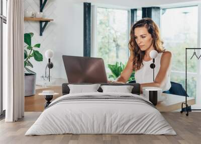 woman using laptop while sitting at home Wall mural