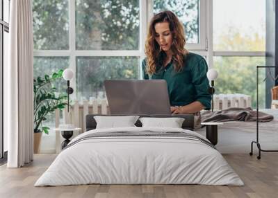 Woman using working on laptop and working from home Wall mural