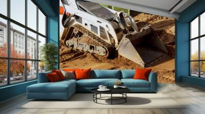 Mini bulldozer with earth doing landscaping works Wall mural