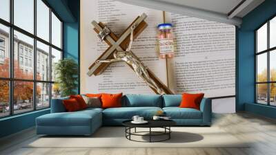 Reading the Word of God the Bible Holy Book with attitude of the church to vaccination and covid-19 vaccine bottle Wall mural