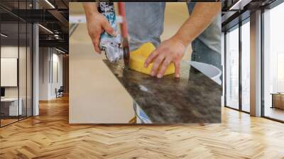 Worker in uses grinder for cutting tiles porcelain stoneware work Wall mural