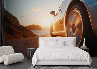 Car cruising along a picturesque seaside road with sun setting over the horizon
 Wall mural