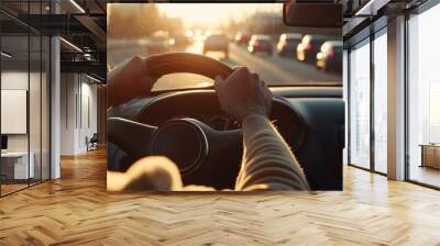 close up of hands on the steering wheel driving down highway, sun shining through window Wall mural