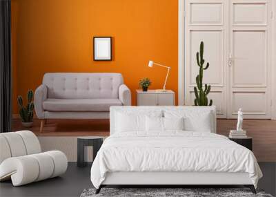 Orange living room, sofa and cupboard, white lamp with many cactus style with carpet. Wall mural